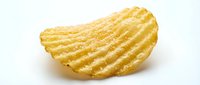 Golden ridged potato chip with textured surface isolated on white background for snack food packaging and culinary design projects.