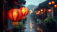 Traditional red Chinese lanterns glowing warmly against moody rainy street backdrop, illuminating ancient architecture with soft orange light in atmospheric evening scene.
