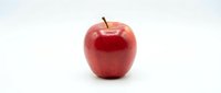 Fresh red apple with stem isolated on white background, suitable for nutrition, health, and food packaging design projects.