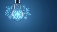 Glowing light bulb with brain inside surrounded by innovation icons on blue background representing creativity, ideas, intelligence and brainstorming concepts.