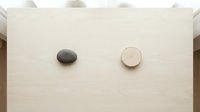 Minimalist wooden board with black stone and wooden circle for spa wellness meditation zen balance natural organic skincare cosmetic product display.