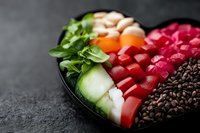 Fresh poke bowl ingredients arranged in rows including raw tuna, salmon, cucumber, radish, seaweed and black rice on dark background, selective focus.