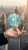 Businessman hand presenting holographic cybersecurity shield icon over blurred city skyline at sunset for digital protection and data security concepts.