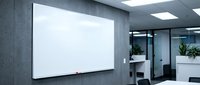 Modern office meeting room with blank whiteboard on gray wall for presentations and brainstorming sessions in corporate workspace environment.