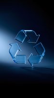Blue glass recycling symbol on dark gradient background for environmental sustainability campaigns and eco-friendly business presentations.