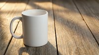 White ceramic mug on wooden table with warm sunlight creating shadows. Mockup template for custom designs, branding, and promotional materials.