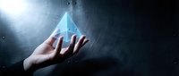 Hand holding glowing blue pyramid with light rays in dark space for technology and innovation concepts in business presentations and digital marketing.