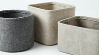 Set of three fabric storage baskets in neutral tones including gray round and beige square containers for home organization and decor on white background.
