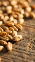 Roasted peanuts scattered on rustic wooden surface with shallow depth of field, suitable for food photography, culinary content, nutrition articles, and healthy snack marketing.