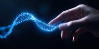 Magical glowing blue light trail follows human finger touch against dark background, creating ethereal wave effect with sparkling particles and mystical energy flow.
