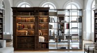 Classic library interior with wooden bookshelves filled with vintage books, elegant arched windows, and reading area for academic research and study.