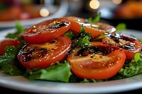 Fresh tomato and spinach salad with balsamic glaze on white plate, healthy Mediterranean cuisine for restaurant menu and food photography.
