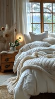 Cozy bedroom interior with unmade white bedding, knitted throw blanket, and natural light streaming through wooden window frame, perfect for lifestyle and home decor marketing.
