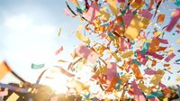 Colorful confetti explosion with bright sunlight creating festive celebration atmosphere for parties, events, and joyful occasions.