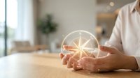 Hands holding glowing compass symbol representing guidance, direction and navigation in modern office environment for business decision making.