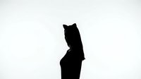Silhouette of a young woman wearing cat ears headband, dark contrast against white background, mysterious and playful mood.