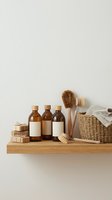 Natural eco-friendly cleaning supplies with amber bottles, wooden brushes and soap bars on shelf for sustainable household maintenance.