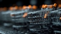 Empty shopping cart in supermarket aisle with warm lighting and blurred background for retail and consumer concepts.