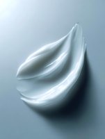 Luxurious white cream texture swirl on light blue background, cosmetic product photography showing smooth moisturizer consistency for skincare advertising.