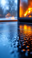 Raindrops on dark surface reflecting warm fireplace glow through window on cold winter evening, creating cozy atmospheric mood for seasonal designs.