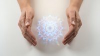 Hands protecting glowing mandala symbol representing spiritual energy, meditation, healing and wellness practices for holistic health concepts.