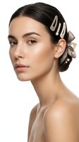 Young woman with elegant hair accessories and natural makeup on white background for beauty and fashion projects.