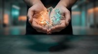 Hands holding glowing puzzle pieces symbolizing connection, teamwork and problem-solving in business environment for corporate presentations.