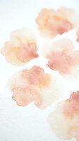 Soft watercolor stains in warm peach and coral tones on white paper texture for artistic backgrounds and creative projects.