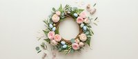Elegant floral wreath with soft pink roses and green eucalyptus leaves on neutral background for wedding decor, spring celebrations and romantic events.
