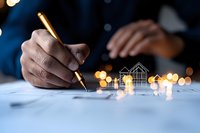 African American businessman signing real estate contract with glowing house sketch and bokeh lights, representing property investment and homeownership dreams.