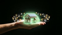 Hand holding glowing house model with floating currency symbols representing real estate investment, mortgage loans, property value and financial planning.