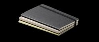 Stacked closed notebooks with black and cream covers isolated on transparent background, ready for clipart, print-on-demand, t-shirt design, stickers, and sublimation projects.
