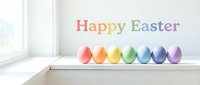 Colorful rainbow Easter eggs lined up on a white windowsill with Happy Easter text, bright natural light, festive spring holiday greeting card.