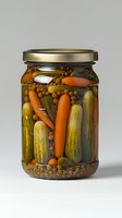 Homemade pickled vegetables in glass jar with carrots, cucumbers and mustard seeds. Preserved food against light gray background for culinary blogs.