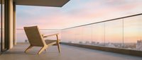 Modern wooden armchair on luxury penthouse balcony overlooking cityscape at sunset, minimalist interior design for contemporary home decor and lifestyle concepts.