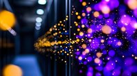 Glowing purple and orange particles burst against dark background, creating dynamic motion effect with bokeh lights and blurred depth for abstract design projects.