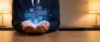 Businessman in suit presenting digital technology icons and data analytics symbols floating above hands in modern office environment.