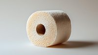Single white toilet paper roll on neutral background showing texture and softness of bathroom tissue, essential household supply for hygiene and cleaning.
