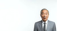 Senior Asian male professional in gray business suit and dark tie displaying surprised or shocked facial expression against white background for corporate communications.