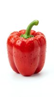 Fresh red bell pepper with water droplets isolated on white background, suitable for food, cooking, nutrition, and healthy eating design projects.