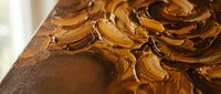 Rich chocolate frosting with smooth swirls and glossy texture on decadent cake surface, perfect for bakery marketing, dessert menus, and culinary content.