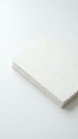 Stack of white textured paper sheets on clean background for stationery and printing projects.