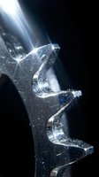 Crystal clear ice formation with dramatic light rays creating prismatic effects and sparkling reflections on dark background for luxury design concepts.