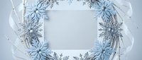 Winter holiday wreath with blue snowflakes and silver ribbon on white background, isolated for seasonal greeting cards and festive decorations.