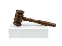 Wooden judge gavel with sound block isolated on white background, representing law, justice, court decisions, and legal authority for litigation and judicial proceedings.