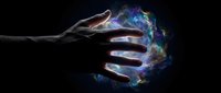 Human hand reaching toward glowing cosmic energy sphere with nebula colors against dark background for fantasy and science fiction concepts.