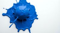 Young adult male with light skin tone, professional scientist or researcher, examining blue virus particle model for educational or medical presentation purposes.