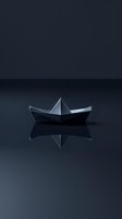 Paper boat origami floating on reflective dark surface with mirror effect against moody black background, minimalist artistic composition.