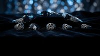 Dark mystical jewelry collection with pentagram symbols and gemstones on textured surface with bokeh lighting for occult and gothic fashion designs.