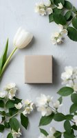 Elegant kraft gift box surrounded by white tulip and jasmine flowers on textured white background for spring celebrations and special occasions.
